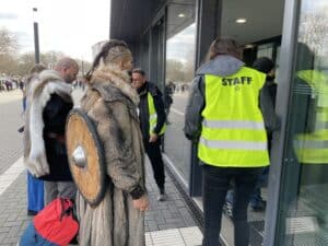 	Costumed attendees entering venue with staff assistance.