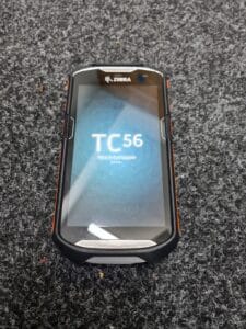 Zebra TC56 touch computer on grey carpet.