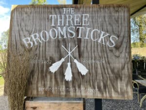 Wooden sign for The Three Broomsticks, serving butterbeer.