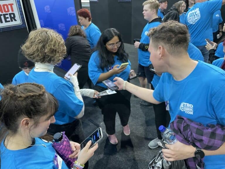 Volunteers in blue shirts busy at Comic Con event