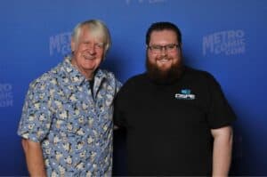Two men smiling at comic con event