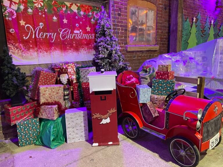Festive Christmas display with gifts and vintage toy car