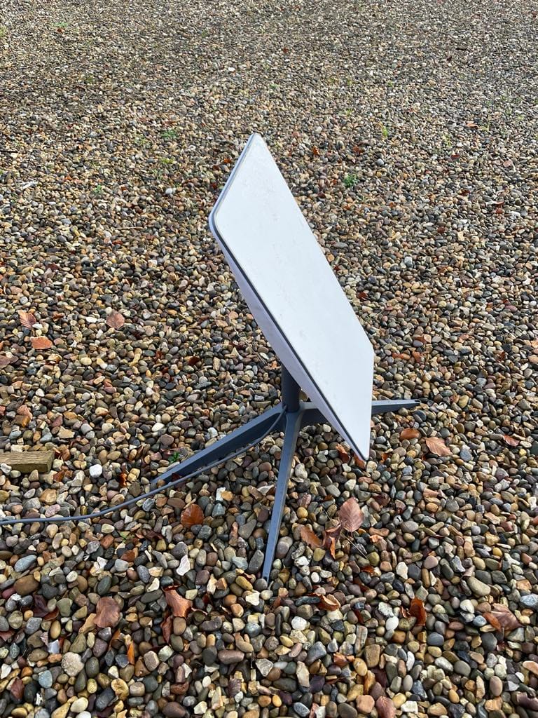 Blank white sign on a pebble ground