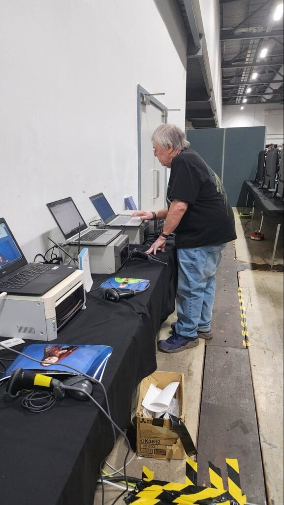 Man examining vintage computers at an exhibition