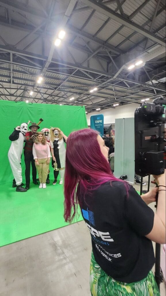 Group in costumes posing at event with photographer