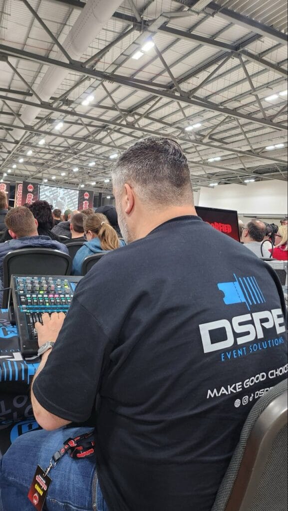 Man operating sound mixer at event