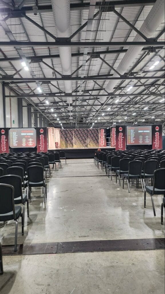 Empty conference hall with rows of chairs and stage