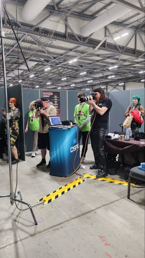 Photographers capturing event at technology expo booth