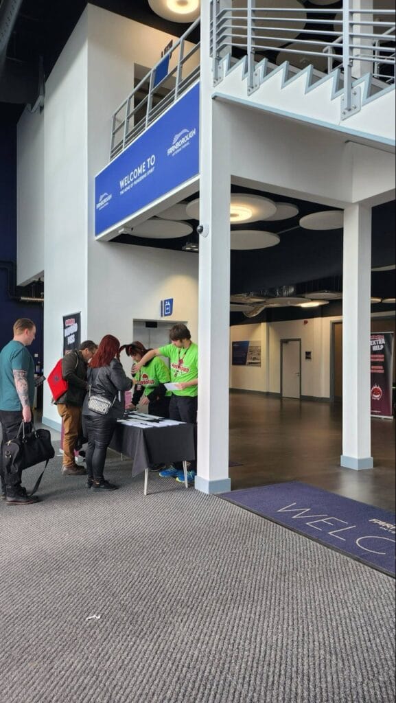Registration desk at Farnborough event with attendees