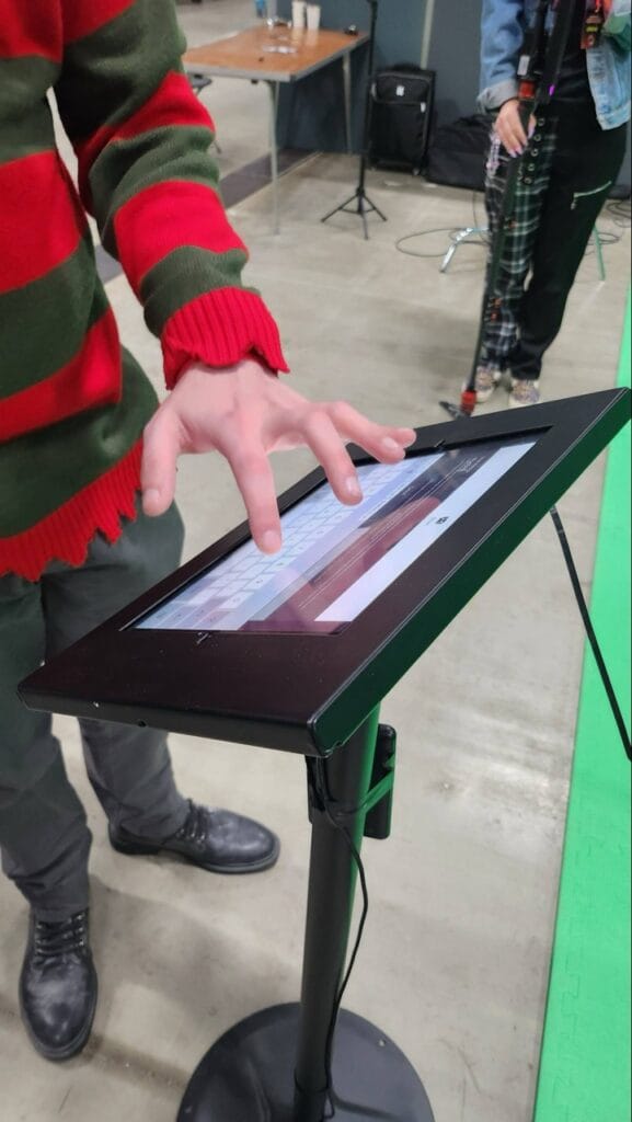 Person using touchscreen kiosk at event
