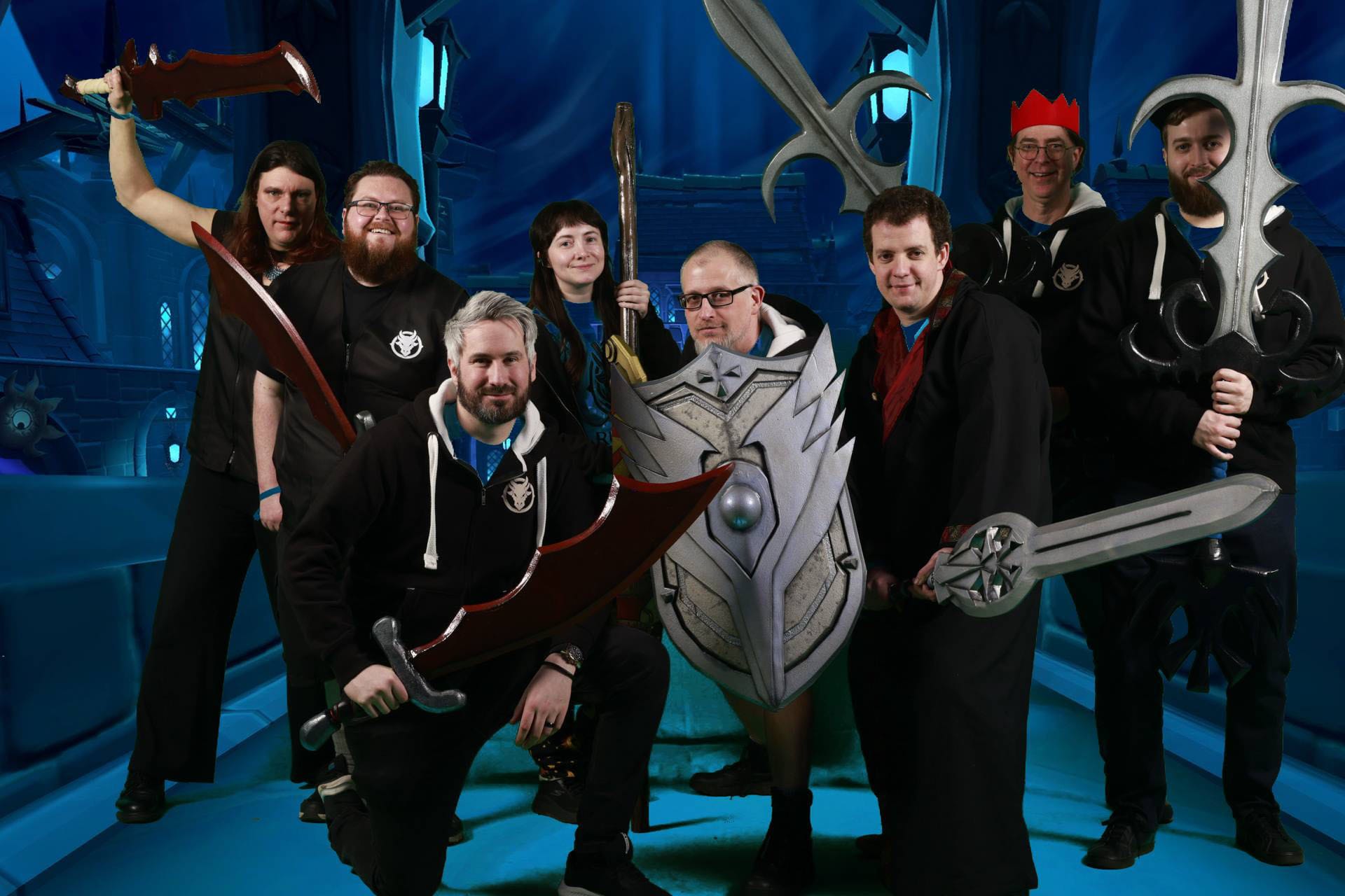 Group in cosplay with fantasy weapons and shield.