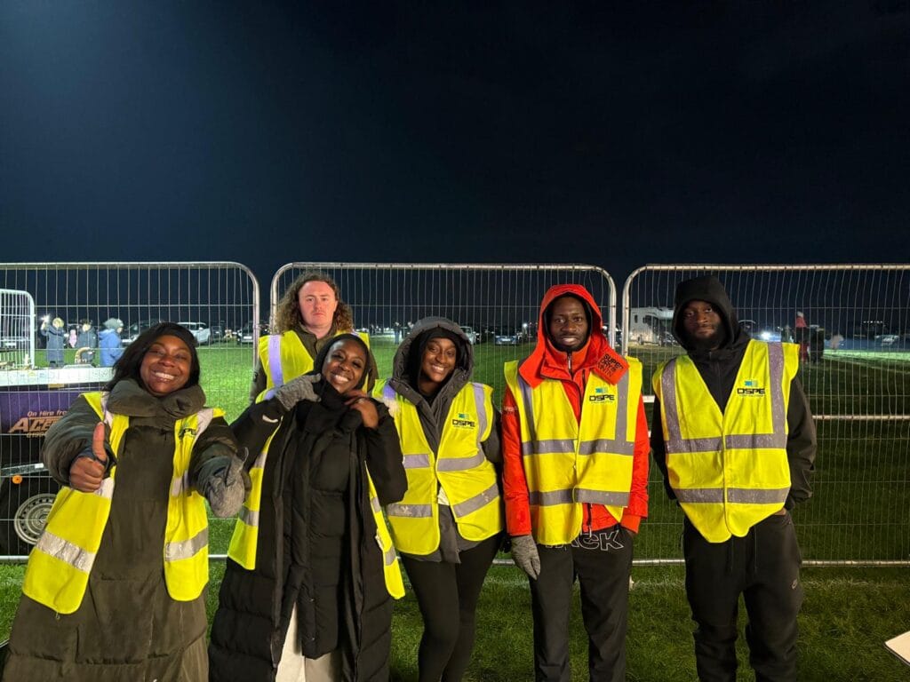 Six staff in hi-vis vests at night event