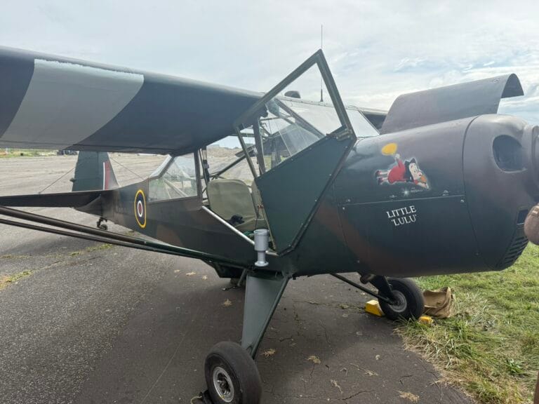 Vintage military aircraft with Little Lulu nose art