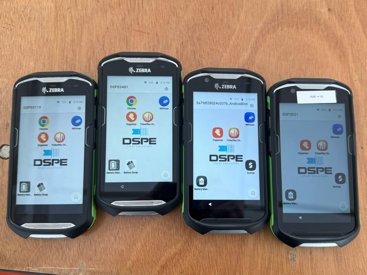 Four Zebra handheld devices on wooden table